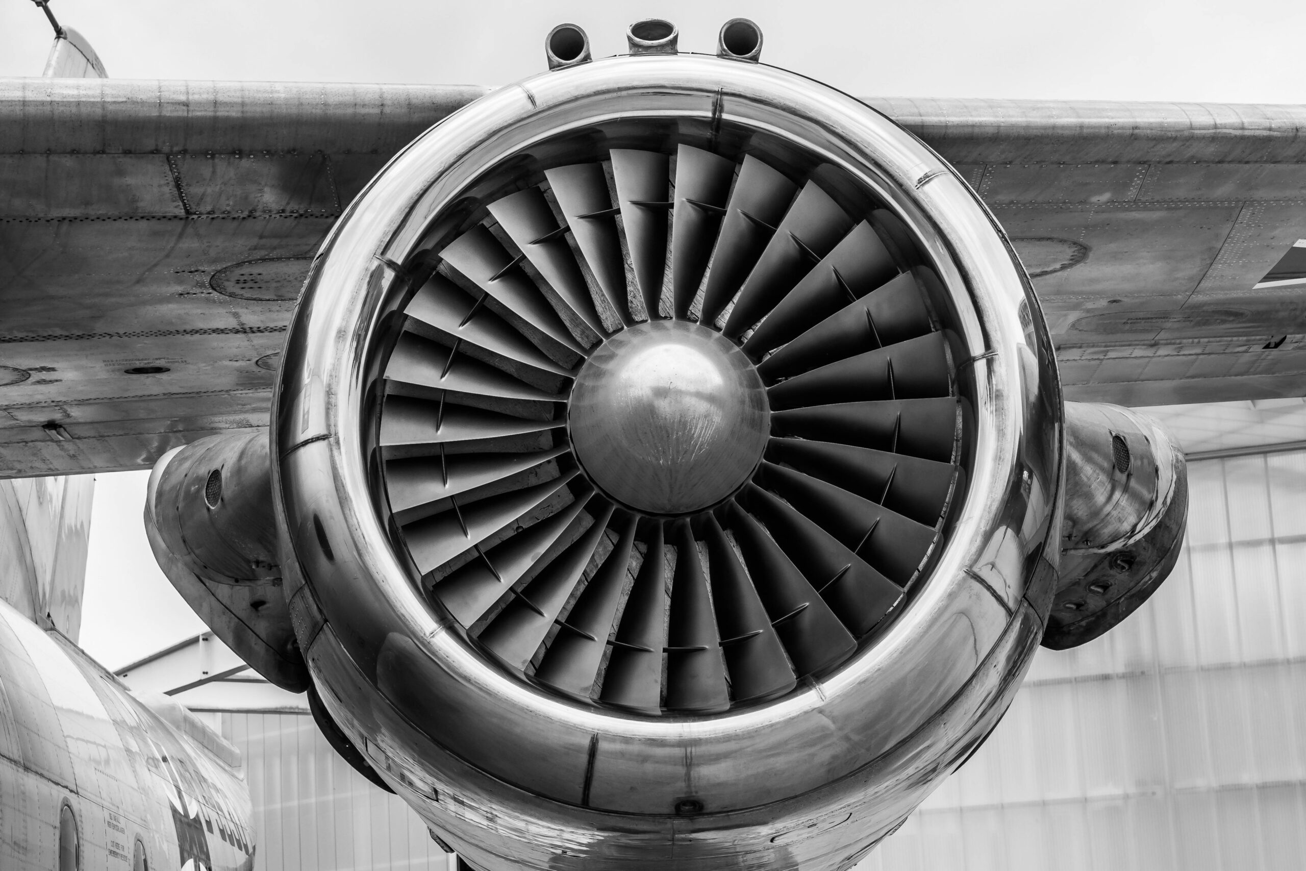 Detailed view of a jet engine in monochrome, showcasing aviation technology.